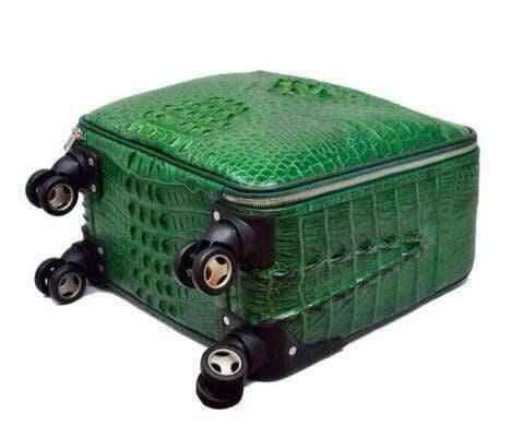 Genuine crocodile leather luxury roller suitcase by Rossie Viren with polished metal accents and sturdy handle.