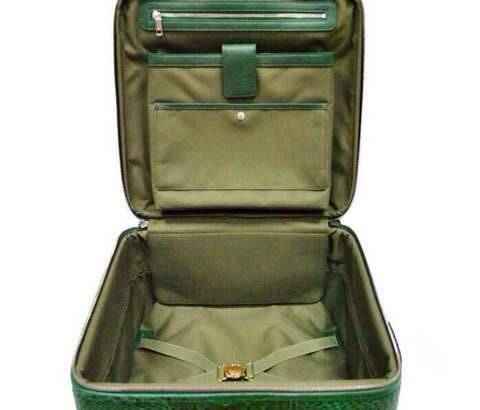 Genuine crocodile leather luxury suitcase with roller bag design by Rossie Viren, featuring polished finishes and sturdy wheels.