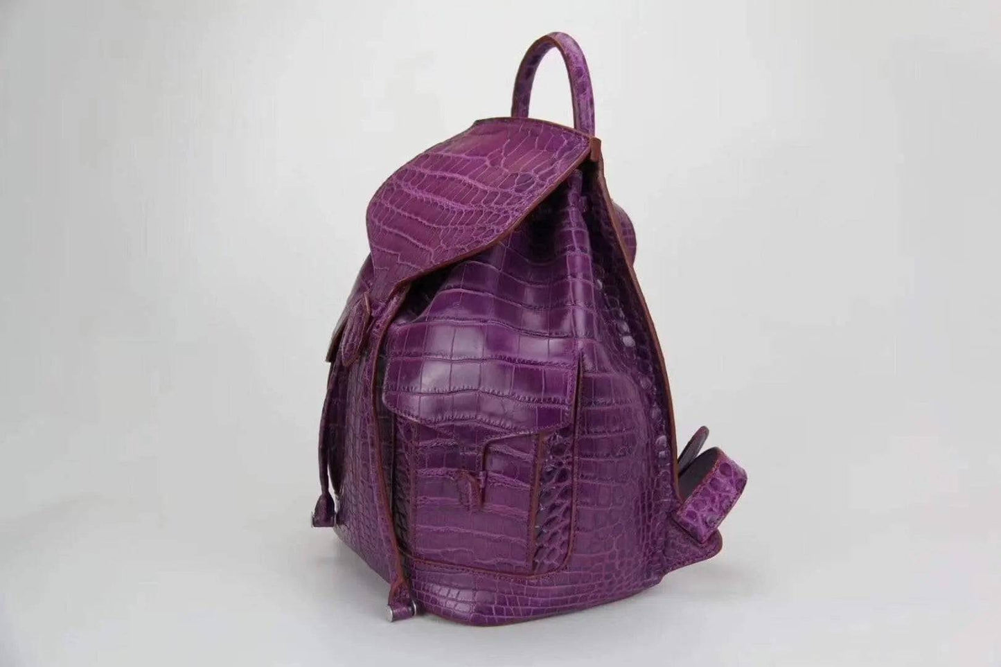 Genuine crocodile belly leather backpack handbag by Rossie Viren, featuring a textured crocodile pattern and sturdy leather straps.