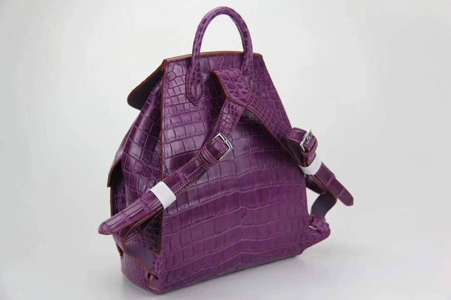 Genuine crocodile belly leather backpack handbag by Rossie Viren, showcasing textured crocodile skin and sleek design.