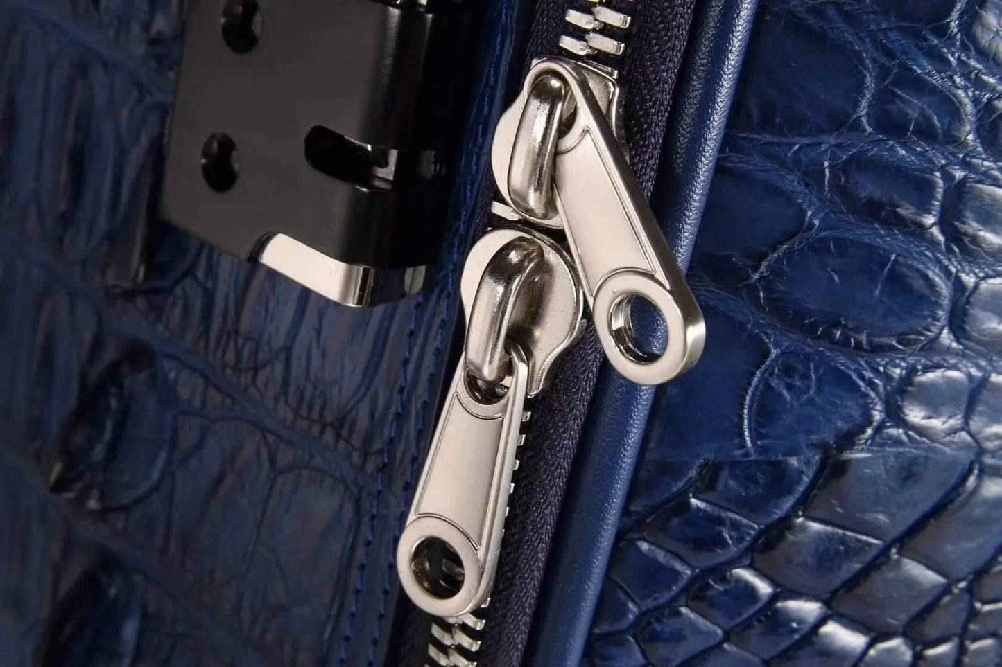 Genuine crocodile leather suitcase with four spinner wheels and sturdy handle, designed for stylish travel by Rossie Viren.