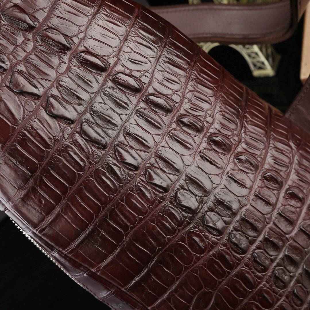 Genuine crocodile leather men's sling chest bag by Rossie Viren, featuring a sleek, textured crocodile pattern and adjustable strap.