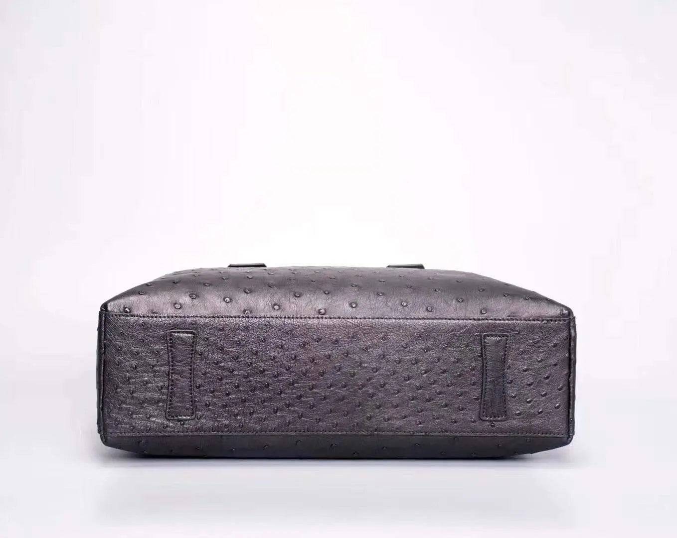 Black genuine ostrich leather briefcase tote bag by Rossie Viren with textured surface and sturdy handles.