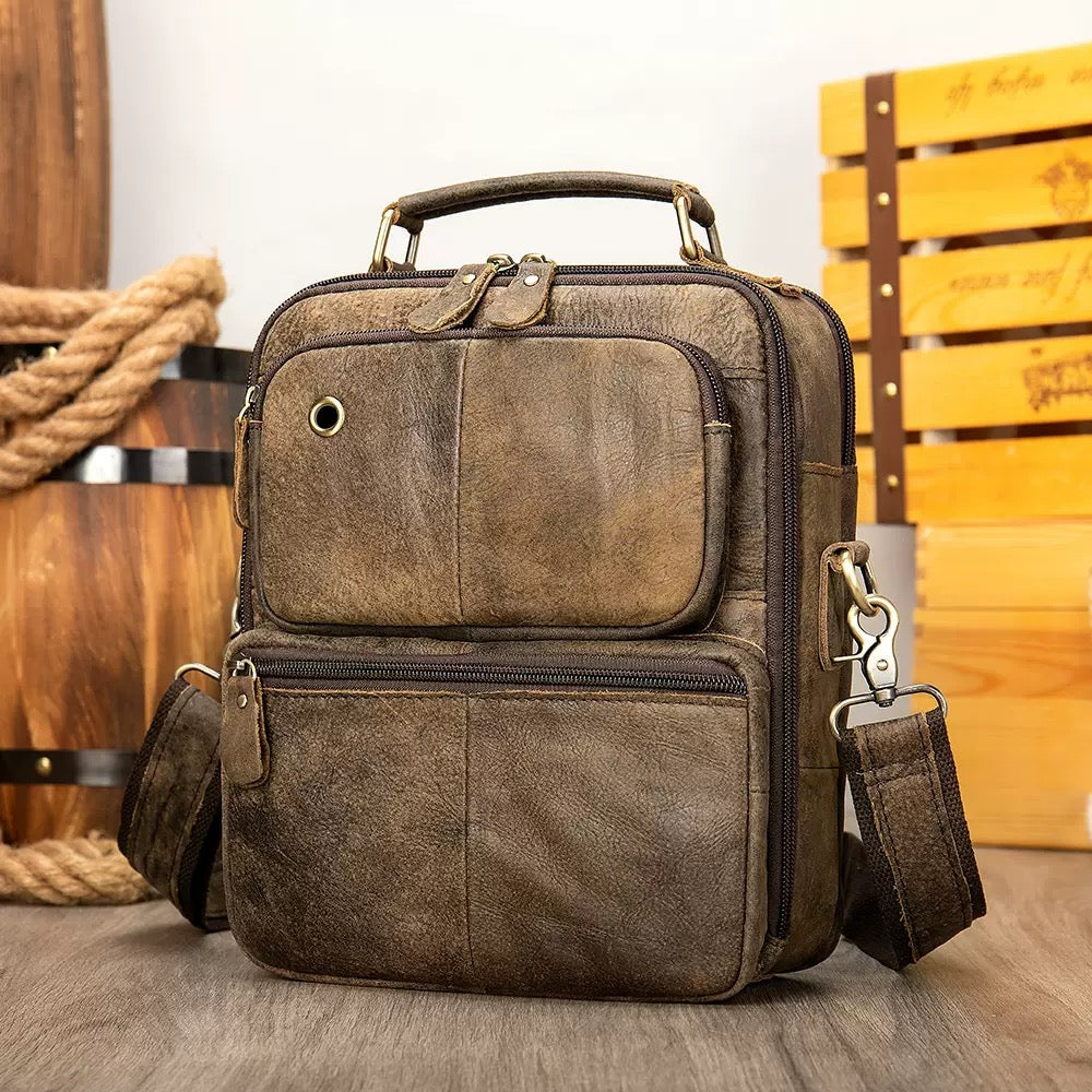 Rossie Viren vintage crossbody handbag with two front pockets, grab handle, and long shoulder strap, displayed on a plain background.