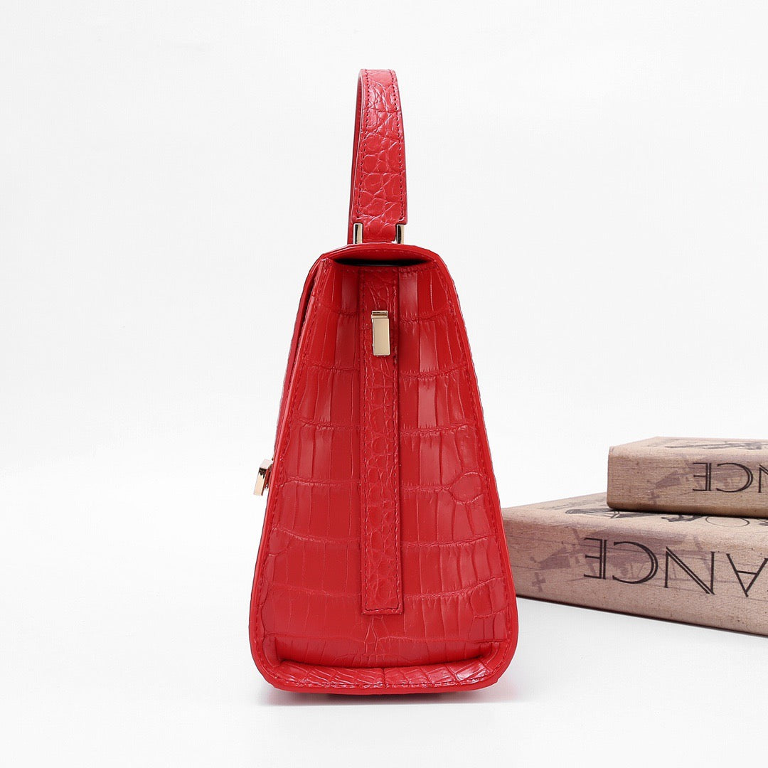 Red genuine crocodile skin leather top handle bag by Rossie Viren, featuring a polished finish and structured design.