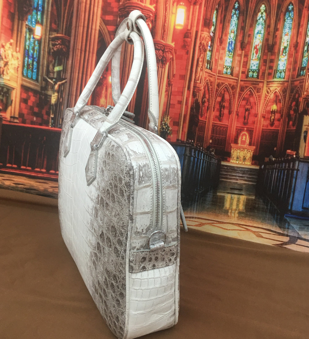 Genuine crocodile belly leather briefcase handbag by Rossie Viren, showcasing a sleek, luxurious design with sturdy handles and elegant finish.