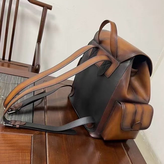 Vintage leather handbag by Rossie Viren with sturdy top handle and adjustable shoulder straps, featuring classic design and brass hardware.