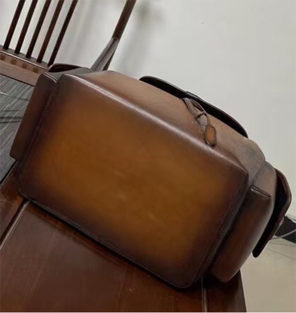 Vintage leather backpack handbag by Rossie Viren with adjustable straps and classic design, shown in a close-up view.