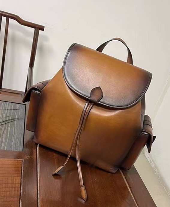 Vintage leather handbag by Rossie Viren featuring a classic design with adjustable straps and brass hardware.