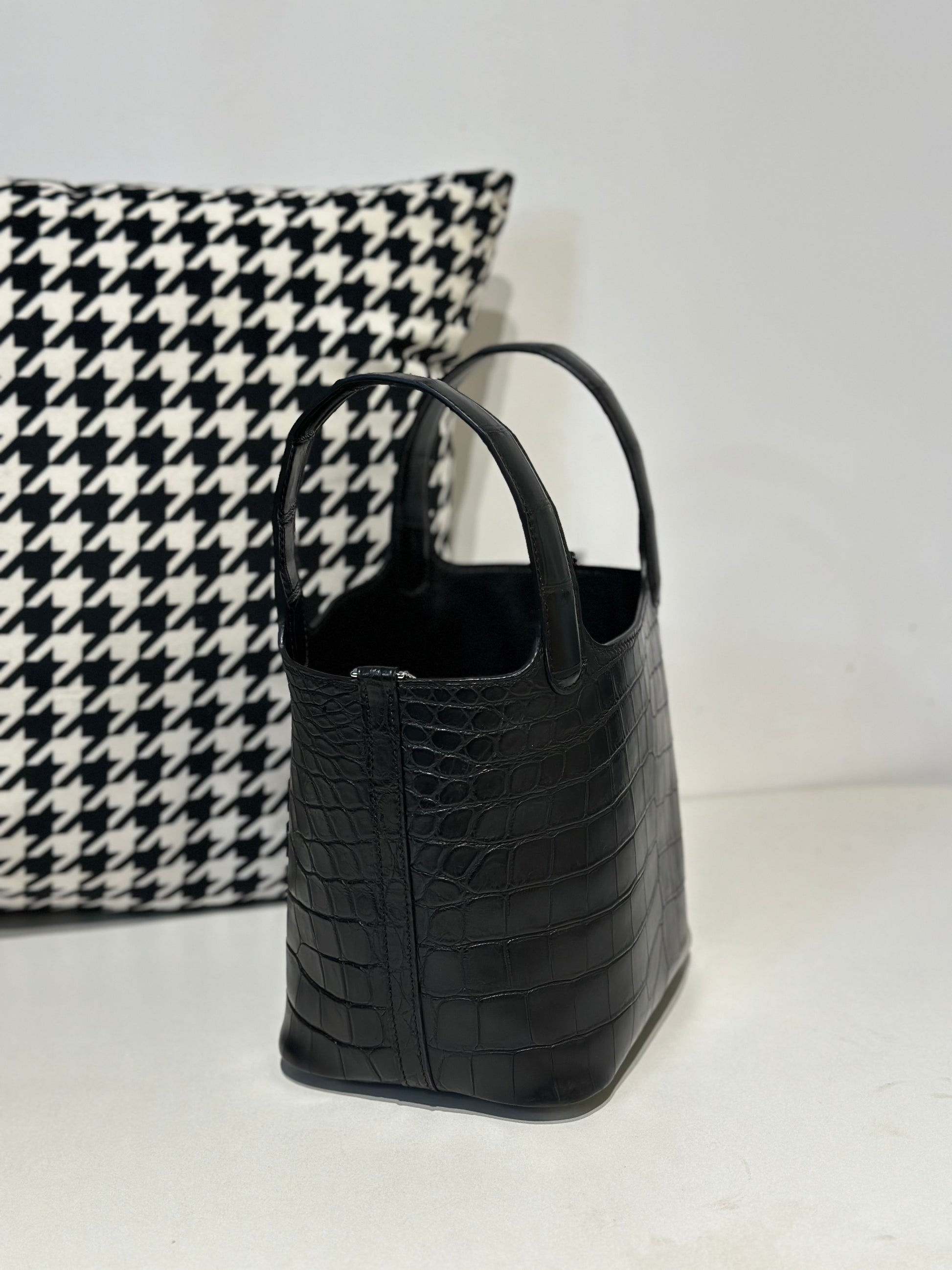 Women's black genuine crocodile leather crossbody bag by Rossie Viren with a sleek, textured surface and compact design.