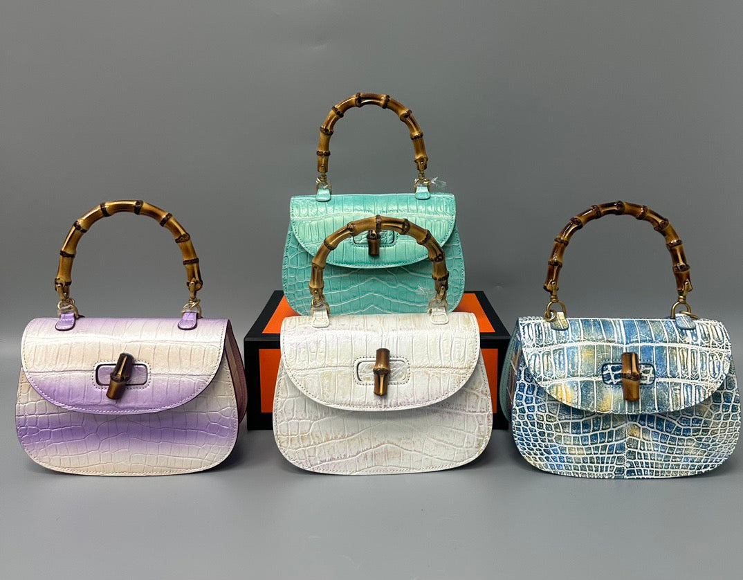 Rossie Viren brushed crocodile skin leather bamboo top handle crossbody handbag, showing its elegant textured surface and bamboo accents.