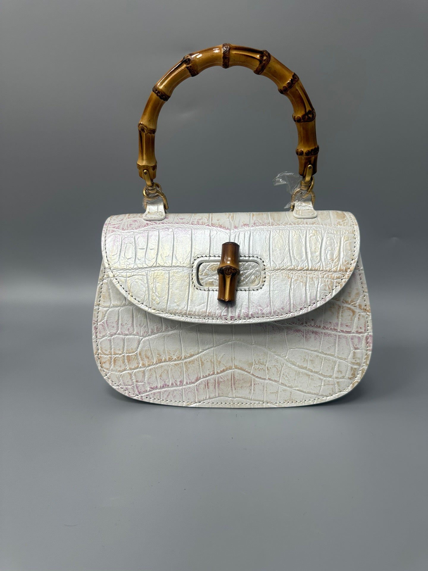 Rossie Viren brushed crocodile skin leather bamboo top handle crossbody handbag with sleek design and textured finish.