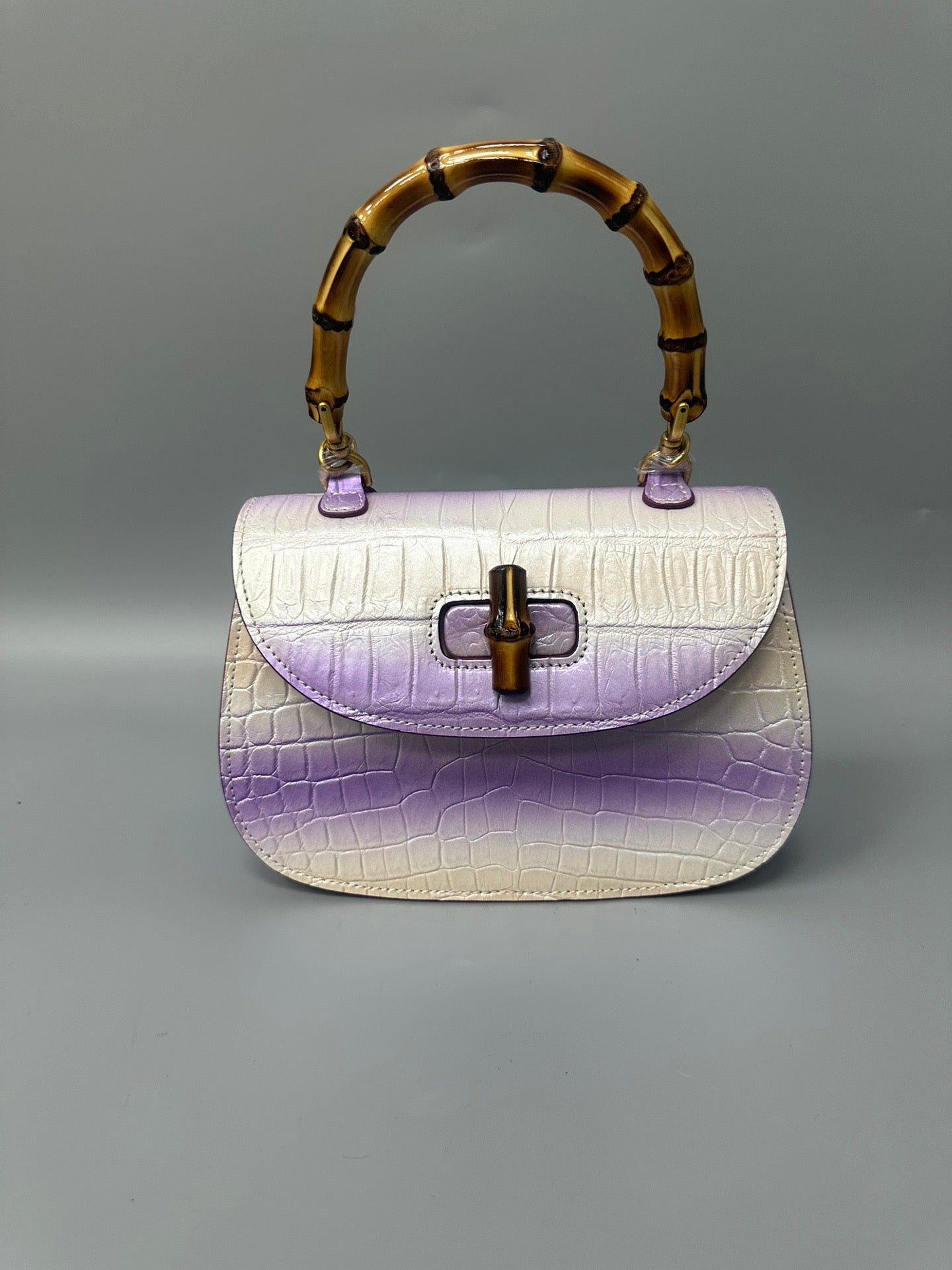 Rossie Viren brushed crocodile skin leather bamboo top handle cross body handbag with elegant design and textured finish.