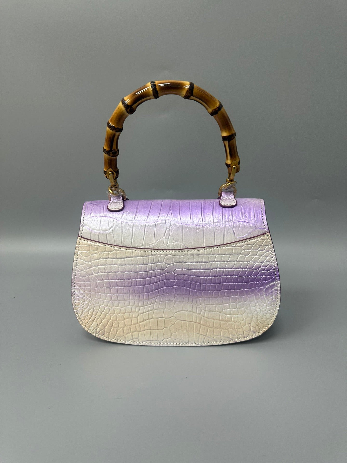 Rossie Viren brushed crocodile skin leather handbag with bamboo top handle, crossbody style, showcasing textured crocodile pattern.
