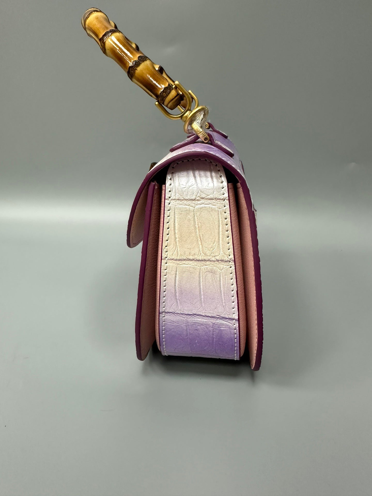 Rossie Viren brushed crocodile skin leather handbag with bamboo top handle, crossbody style, featuring elegant textured finish.