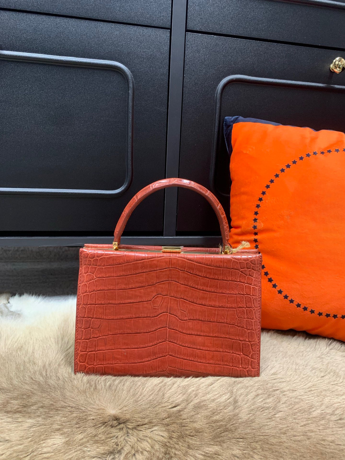 Crocodile leather evening clutch bag with top handle by Rossie Viren, featuring a sleek, luxurious design for formal occasions.