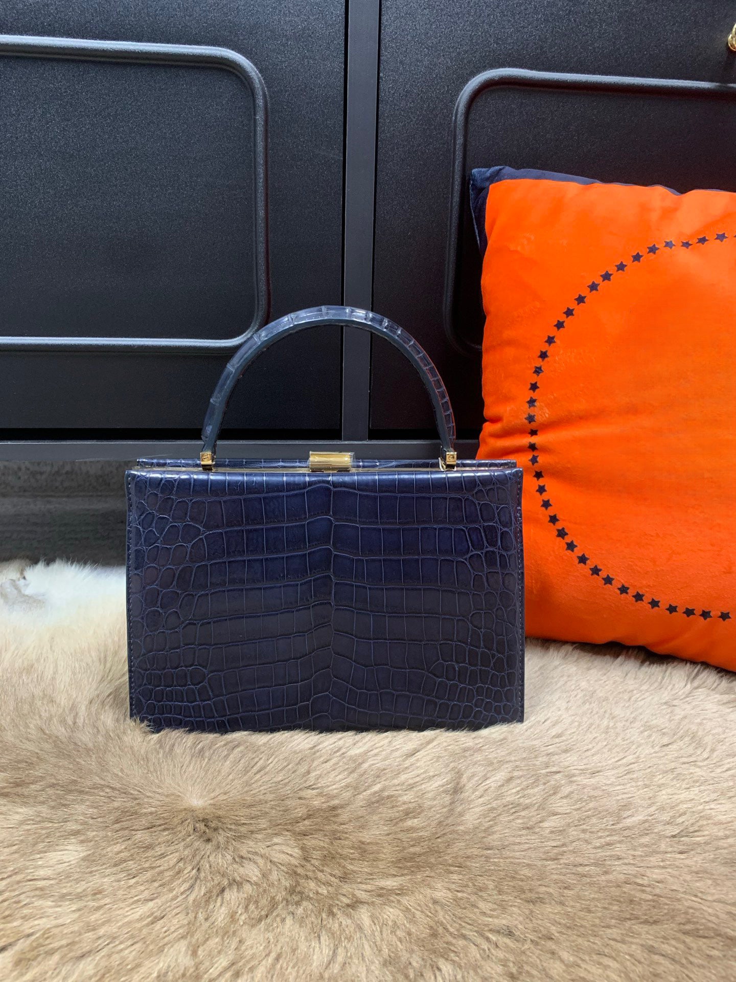 Rossie Viren crocodile leather evening clutch bag with top handle, stylish and compact for elegant occasions.
