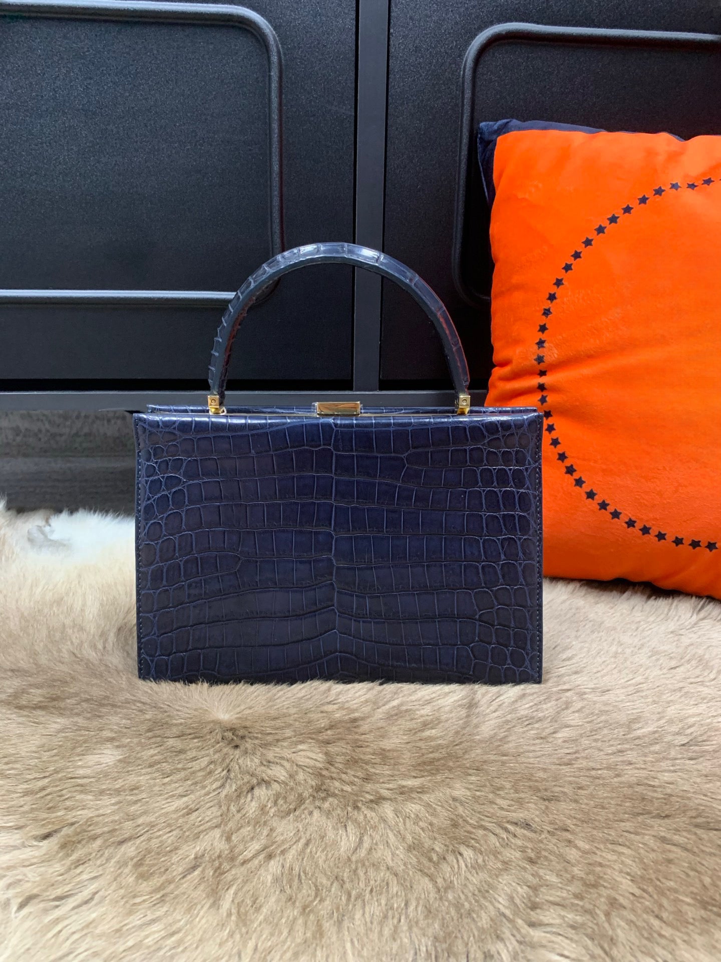 Crocodile leather evening clutch purse with top handle by Rossie Viren, featuring a sleek and elegant handbag design.