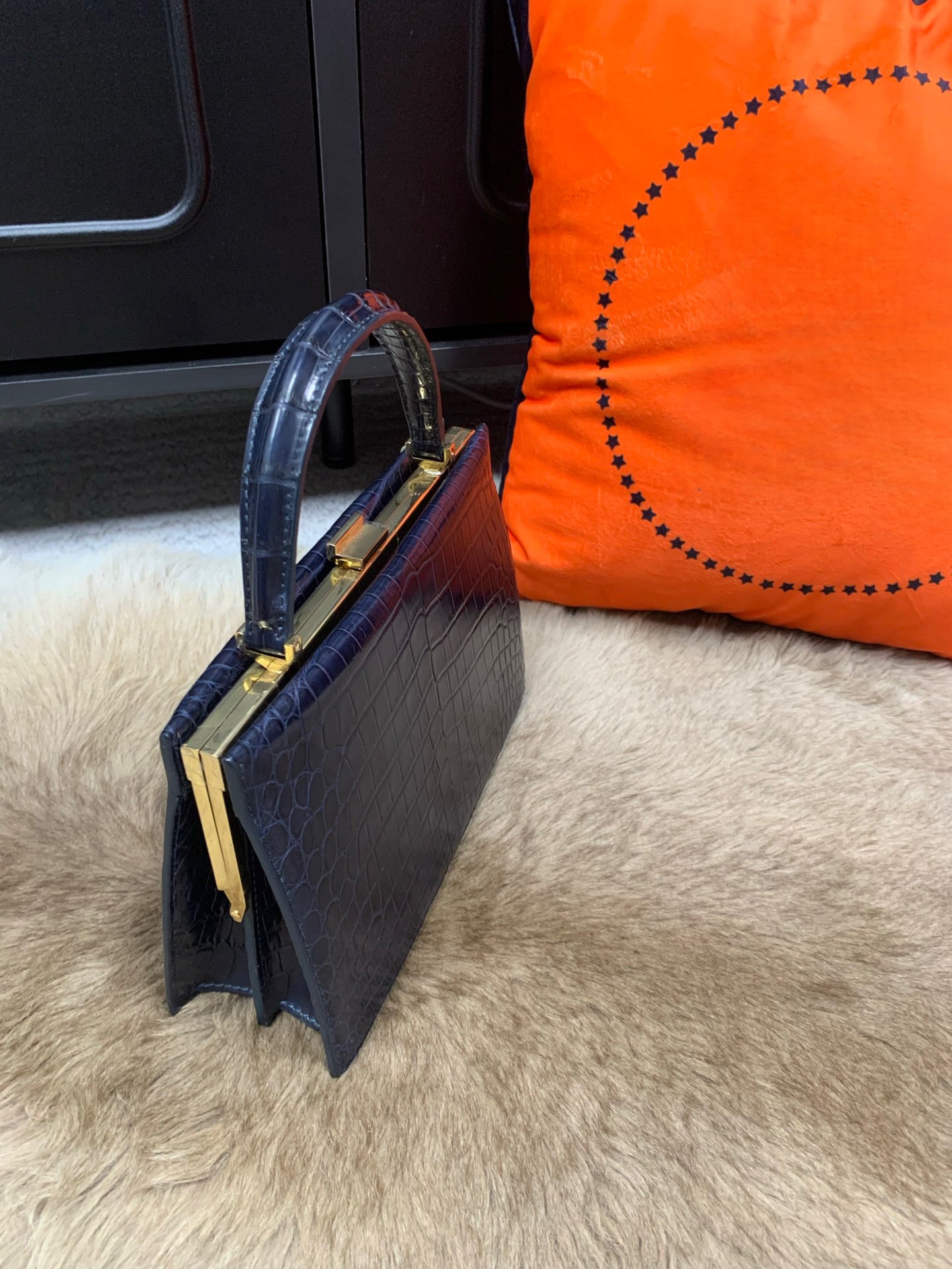 Rossie Viren crocodile leather evening clutch bag with top handle, elegant and textured for formal occasions.