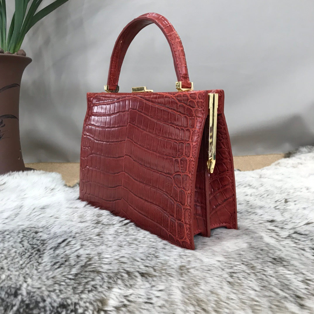 Rossie Viren crocodile leather evening clutch handbag with top handle and elegant design, perfect for formal occasions.