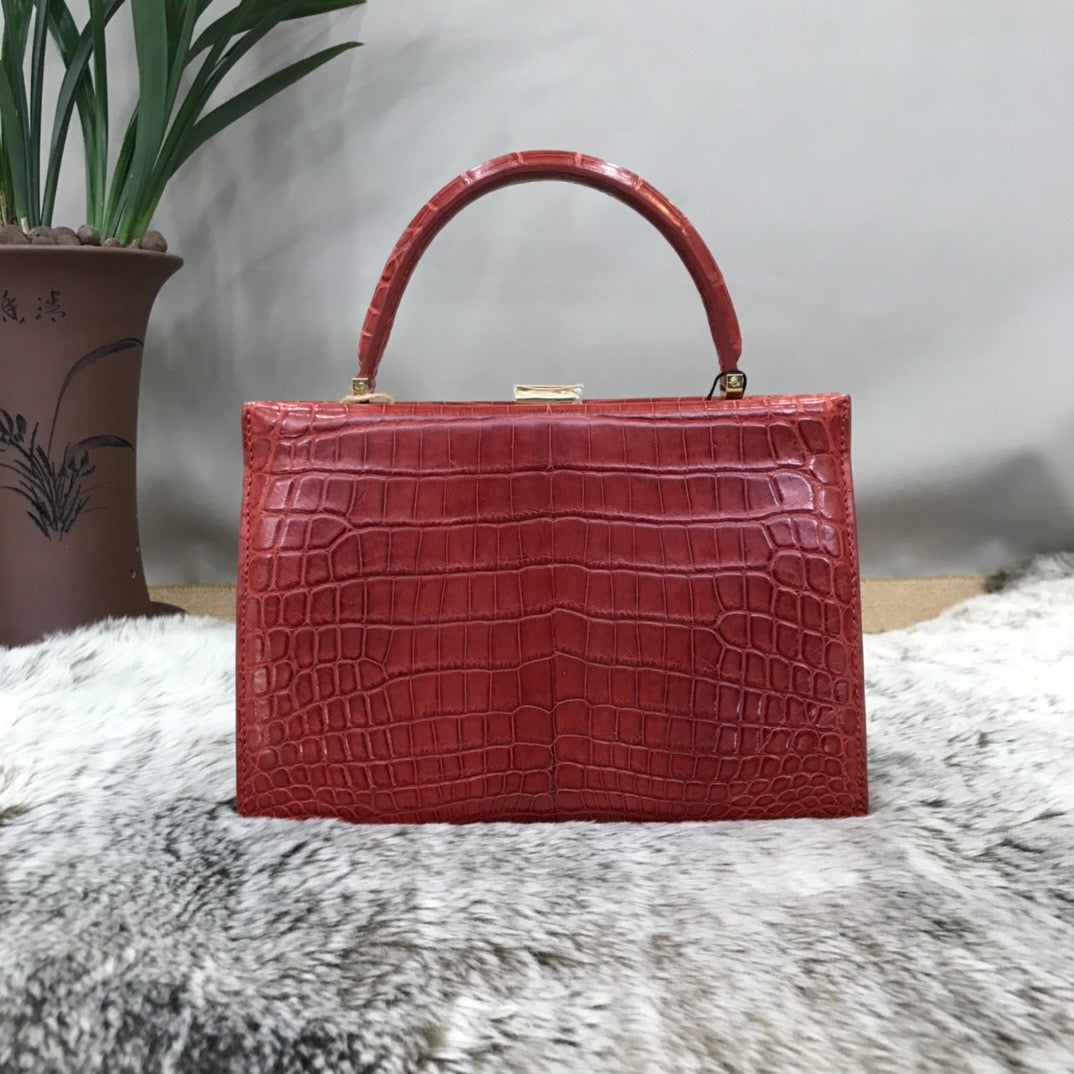 Rossie Viren crocodile leather evening clutch bag with a top handle, stylish and elegant for formal occasions.