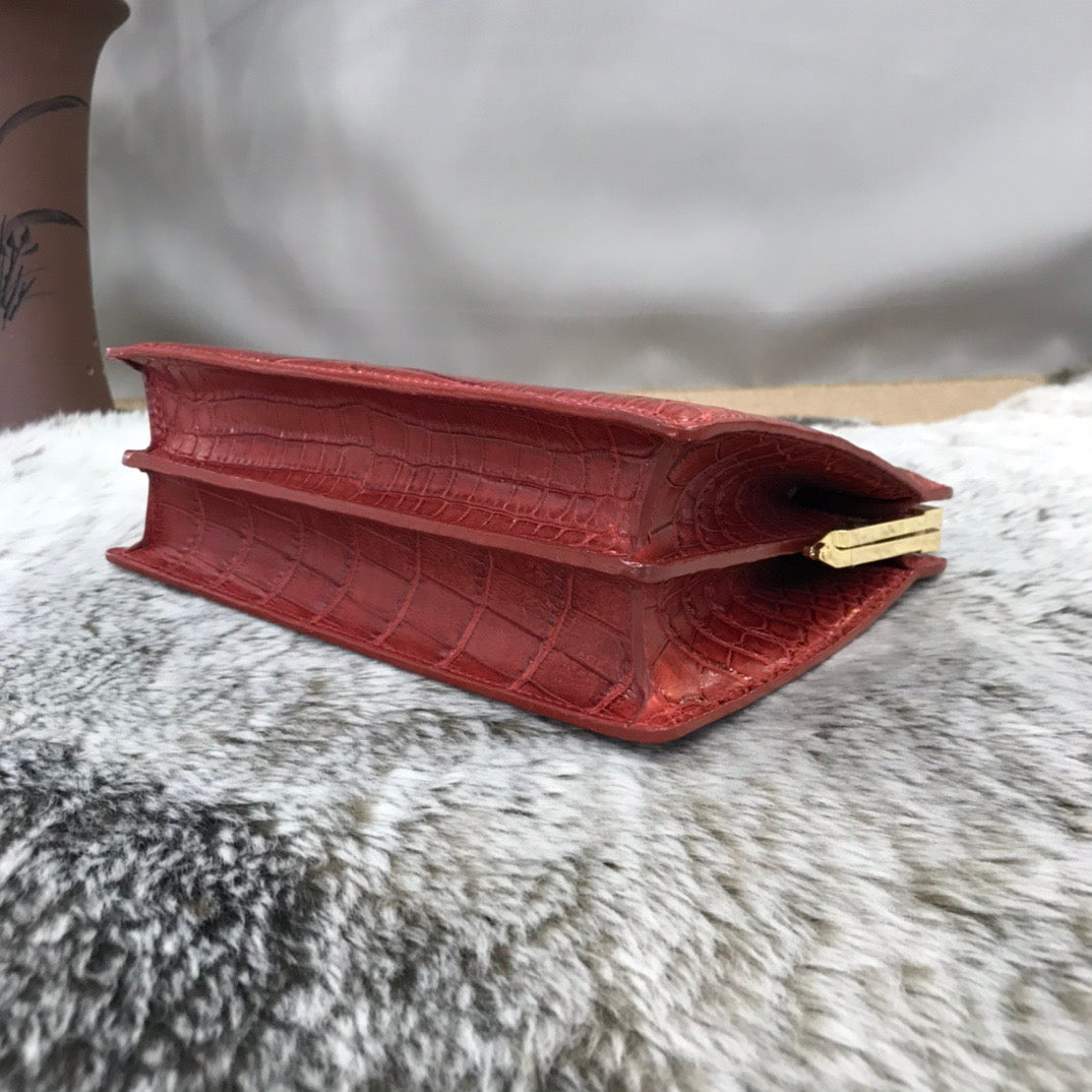 Crocodile leather evening clutch bag with top handle by Rossie Viren, featuring a stylish and elegant design.