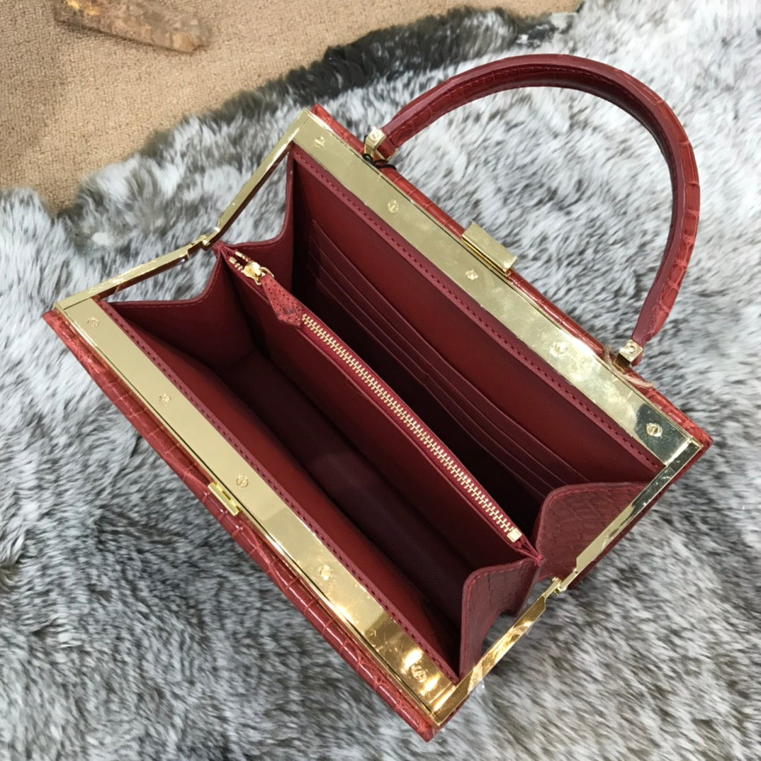 Rossie Viren crocodile leather evening clutch handbag with top handle, elegant design and textured surface for formal occasions.