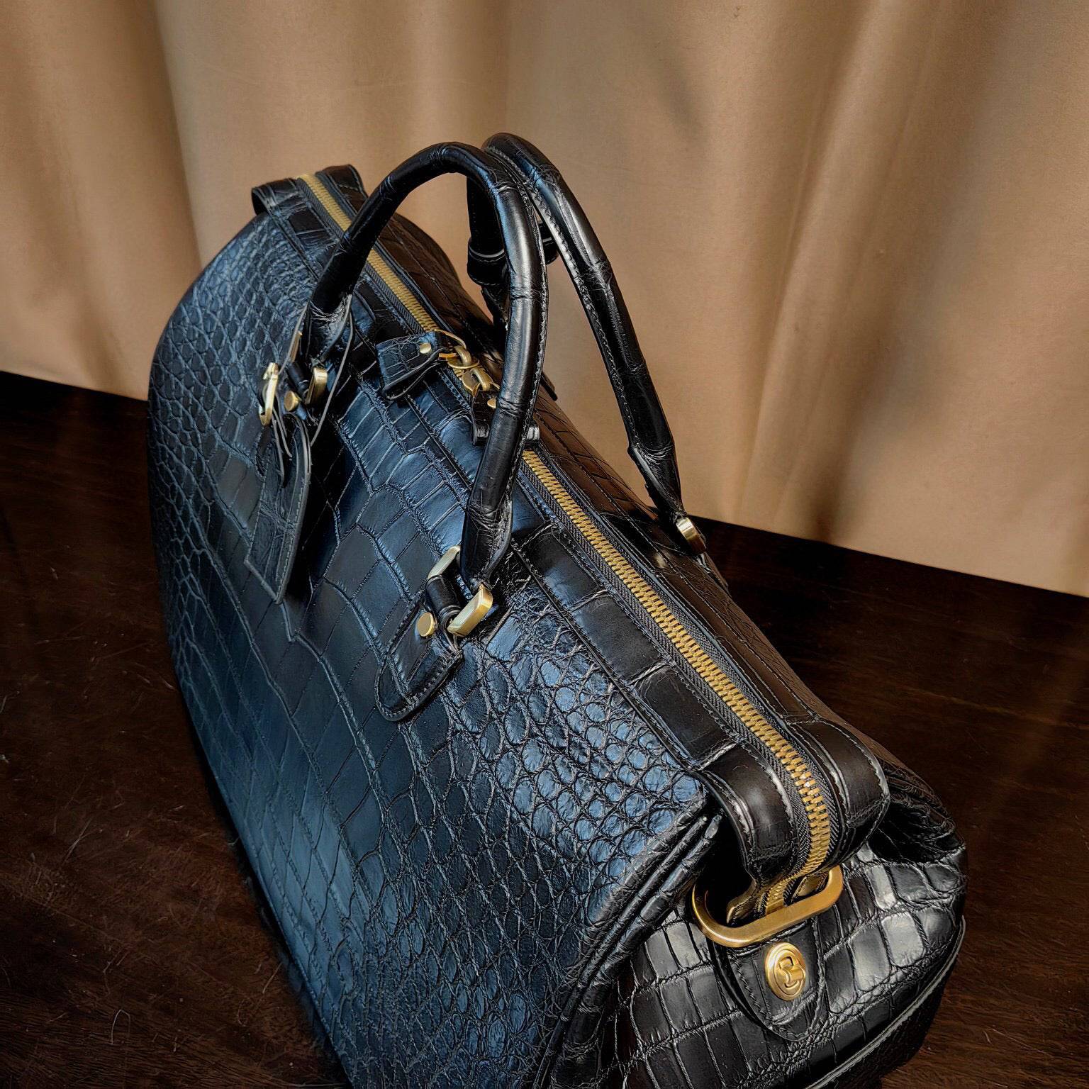 Genuine crocodile leather Super XL travel duffel bag by Rossie Viren with sturdy handles and spacious interior.