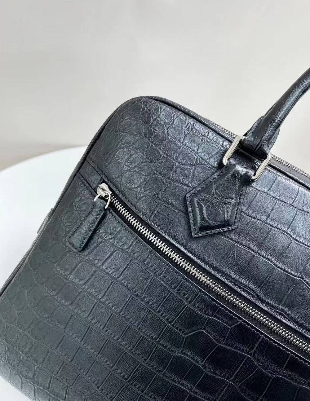 Genuine crocodile skin leather briefcase by Rossie Viren, featuring a sleek handbag design with textured crocodile pattern.