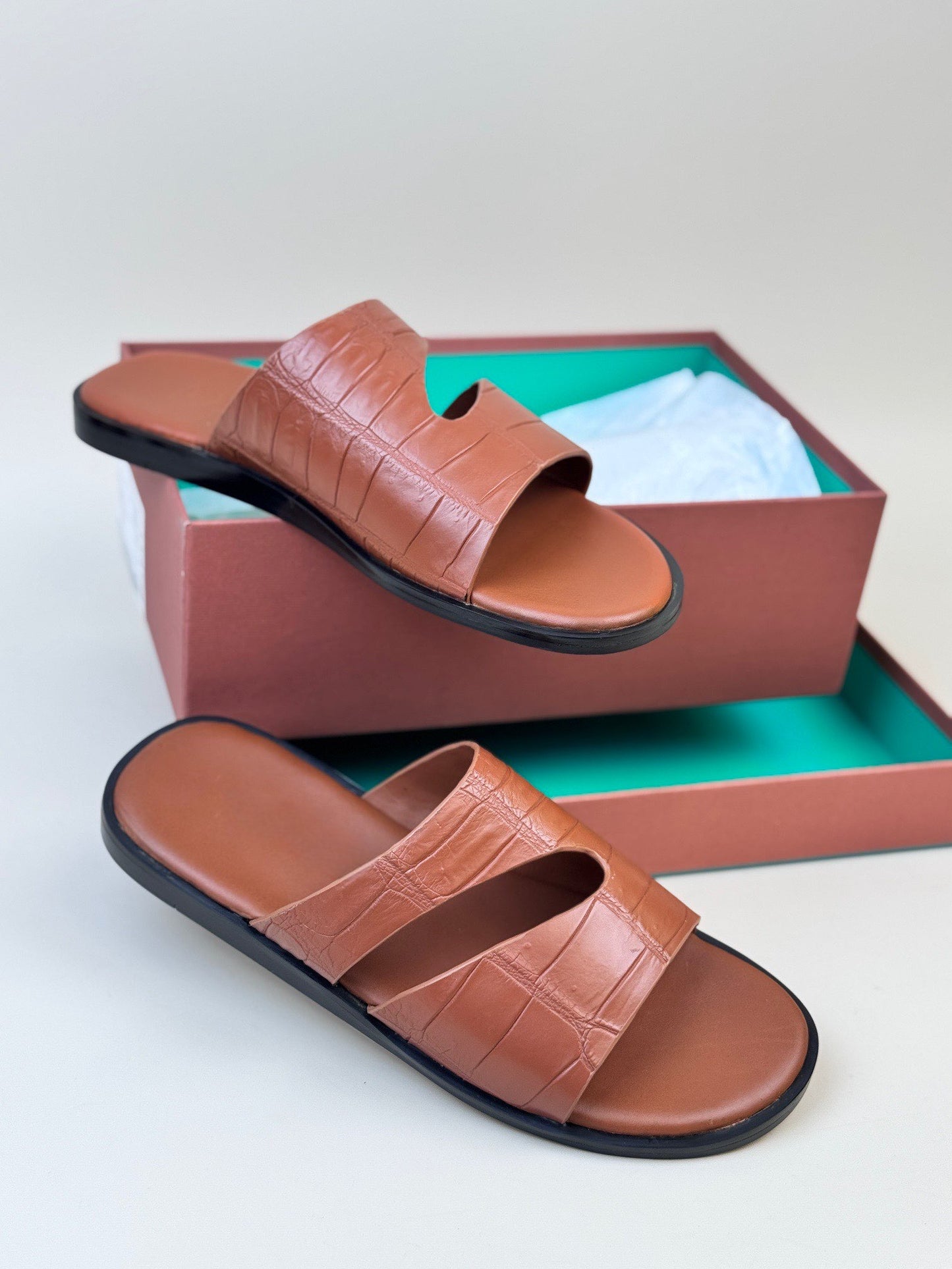 Men's crocodile leather slippers by Rossie Viren featuring a slip-on design and textured crocodile pattern.