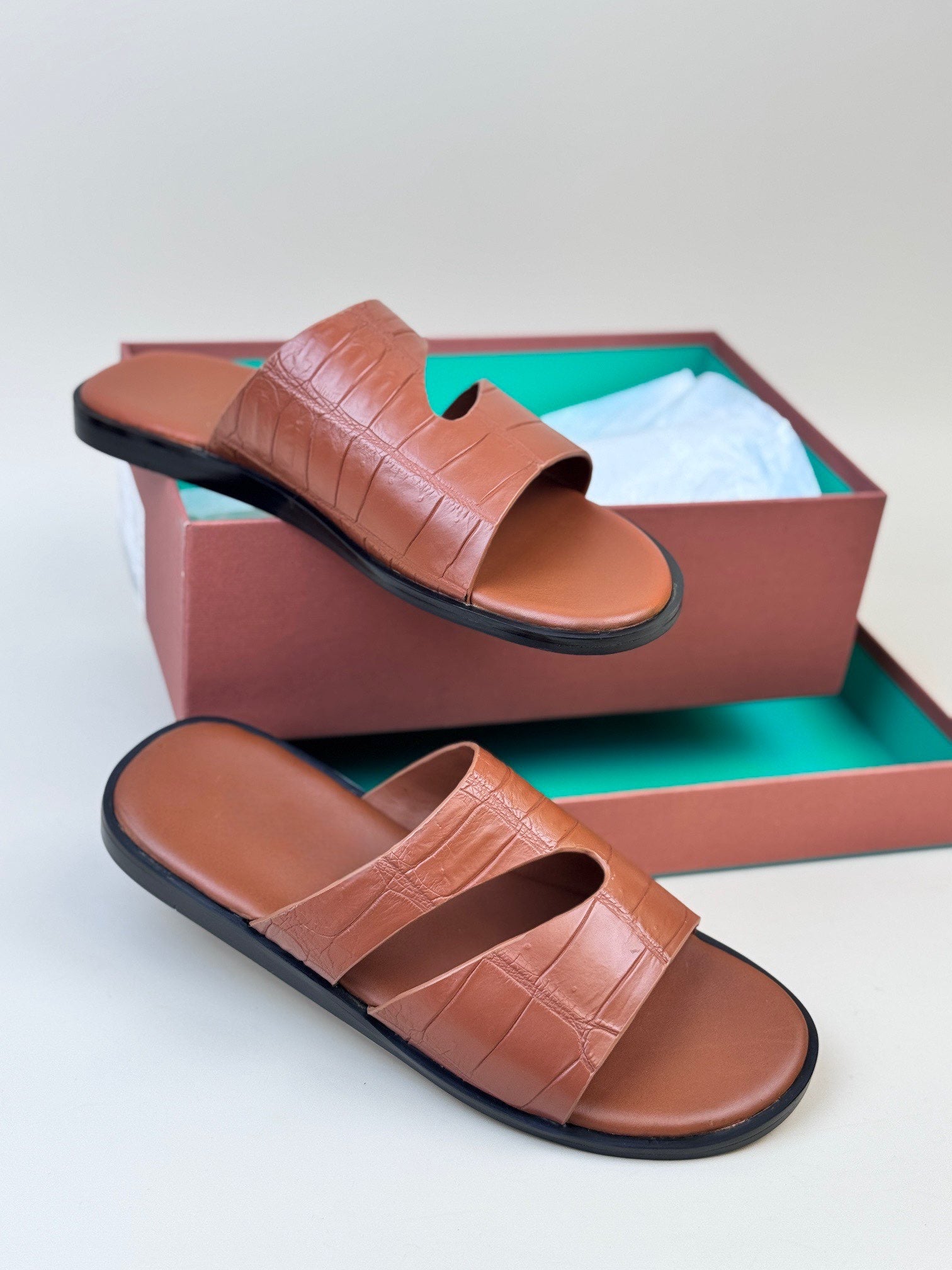 Men's crocodile leather slippers by Rossie Viren featuring a slip-on design and textured crocodile pattern.