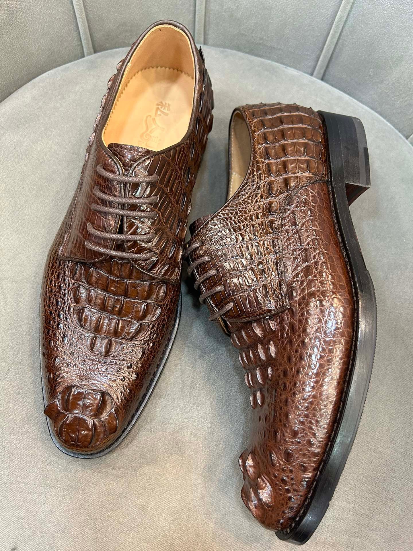Rossie Viren men's crocodile leather dress shoes with cap toe, lace-up style, and Goodyear sole, shown from the side.
