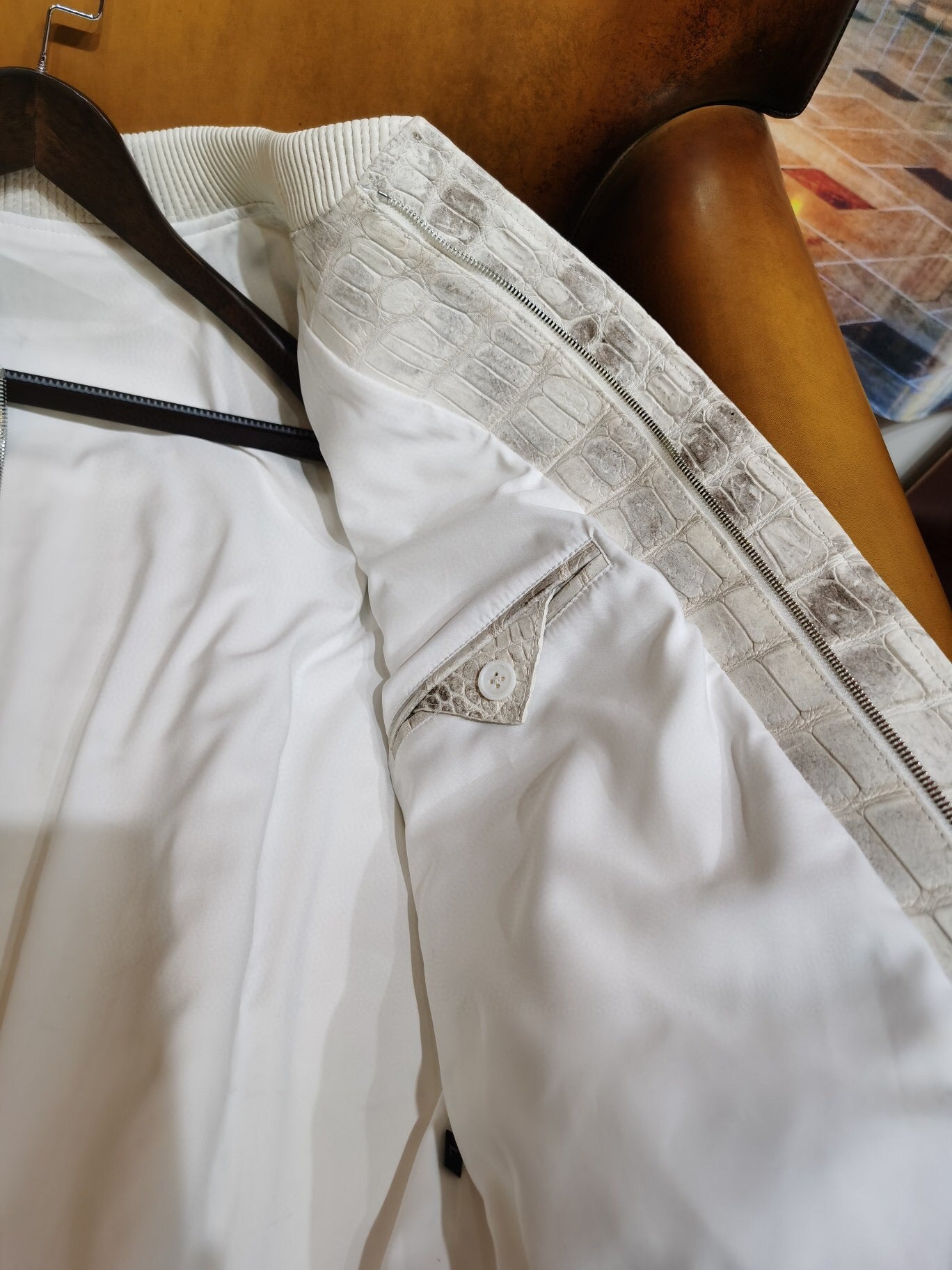Himalaya white crocodile leather jacket by Rossie Viren with wool accents, showcasing luxurious textured crocodile skin and stylish design.