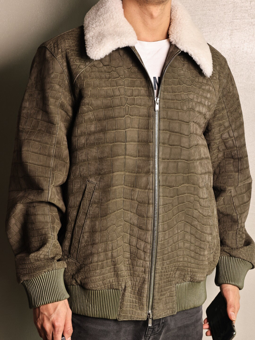 Green crocodile leather jacket with wool collar and zip-up front, casual coat by Rossie Viren, featuring a rat tail design.