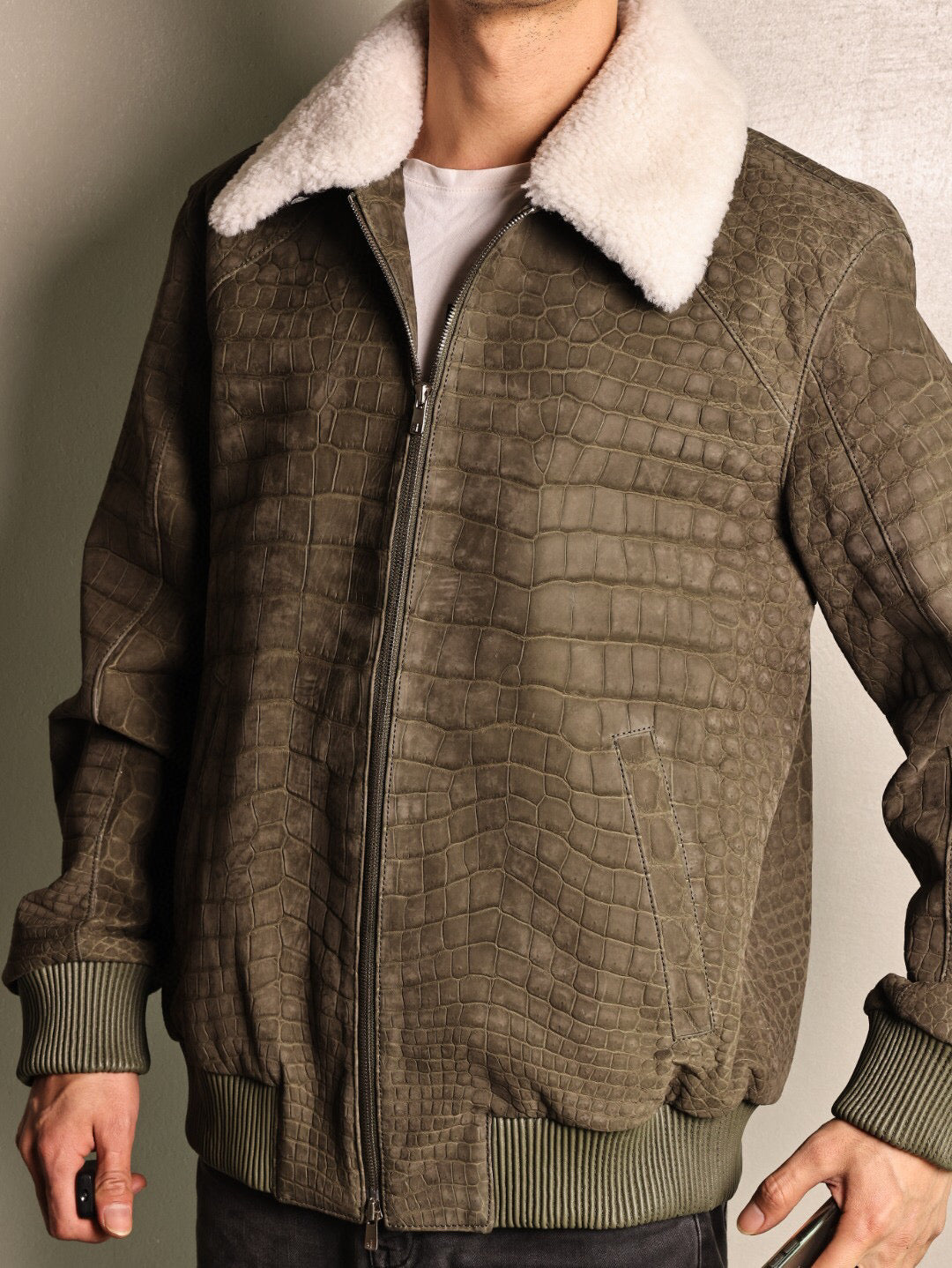 Green crocodile leather jacket with wool collar and zip-up front, casual coat by Rossie Viren, featuring a rat tail design.