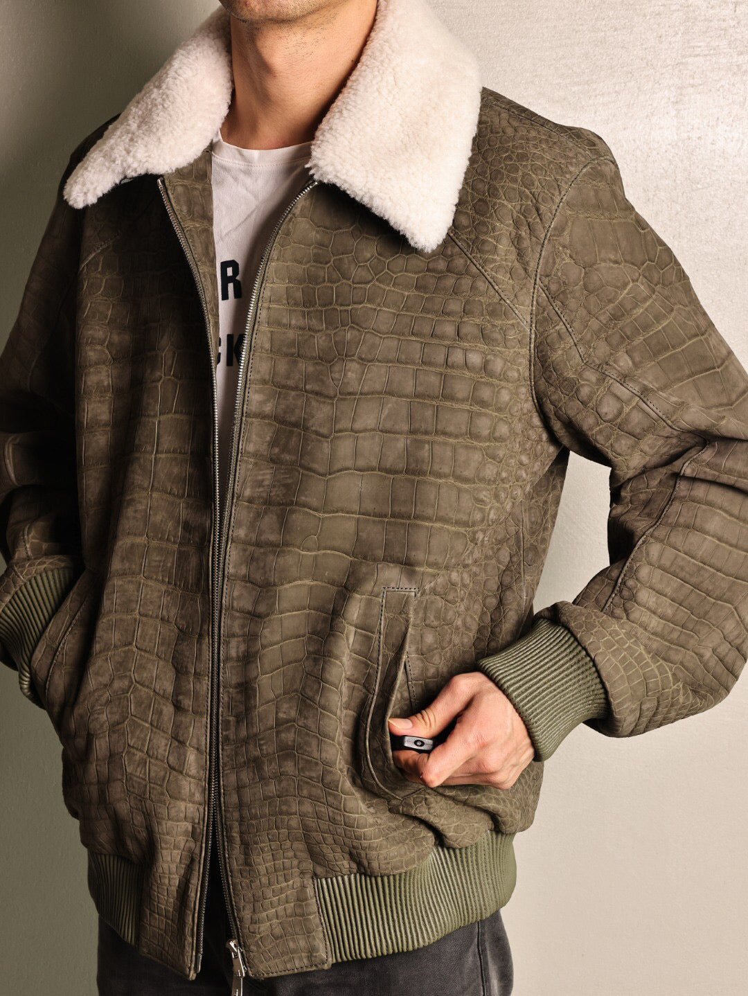 Green crocodile leather jacket with wool collar and zip-up closure, casual coat featuring a rat tail design by Rossie Viren.
