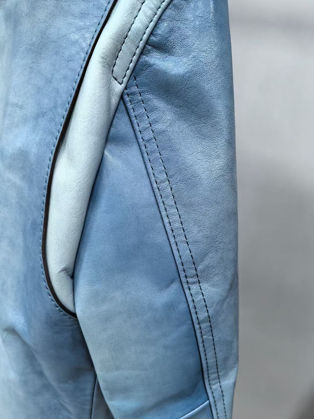 Vintage blue men's leather jacket by Rossie Viren, featuring classic style and textured leather for a timeless look.