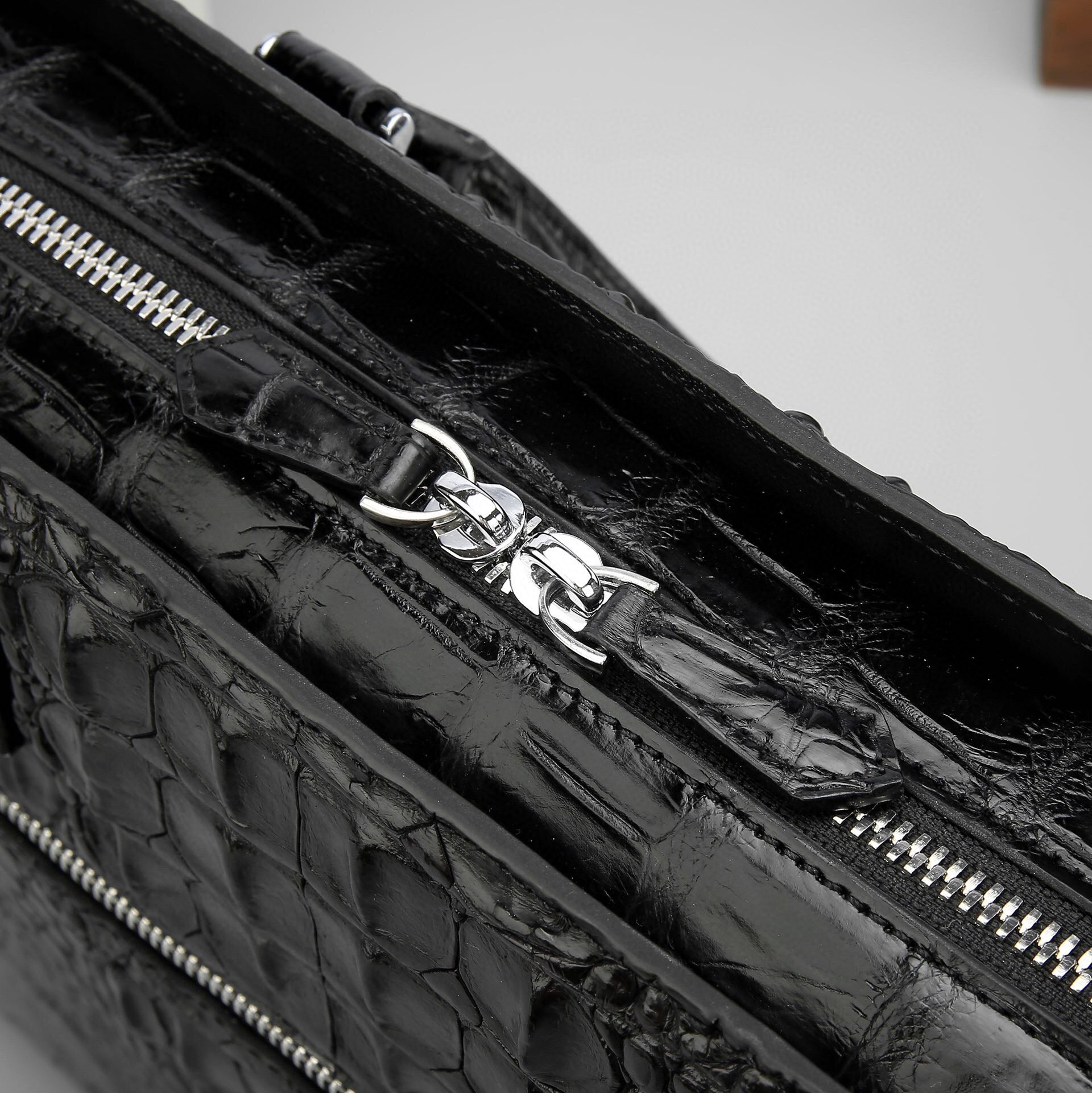 Genuine crocodile leather business briefcase by Rossie Viren, featuring a sleek, structured handbag design with a top handle.