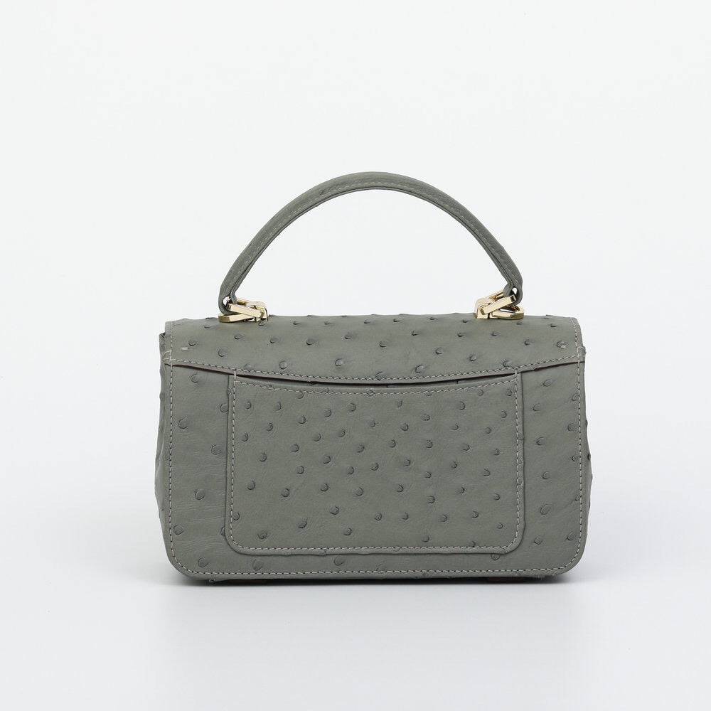 Rossie Viren women's ostrich leather mini flap chain bag with top handle and crossbody strap, showing textured leather and chain details.