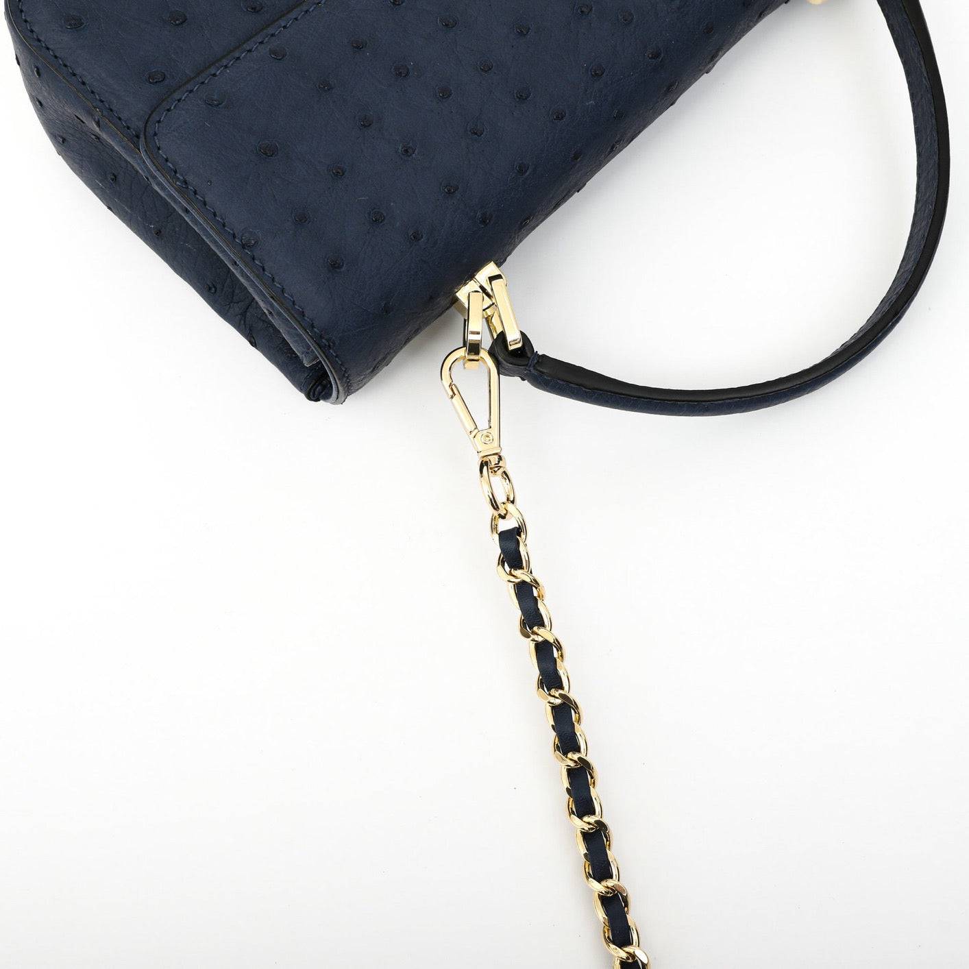 Rossie Viren women's ostrich leather mini flap chain bag with top handle and crossbody strap, featuring a stylish design and chain details.