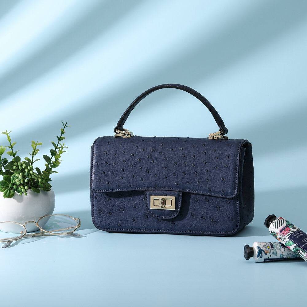 Women's Rossie Viren ostrich leather mini flap chain handbag with top handle and crossbody strap, stylish and compact.
