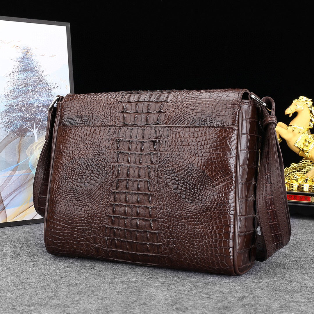 Genuine crocodile leather postal messenger handbag by Rossie Viren featuring a sleek, structured design with a flap closure.