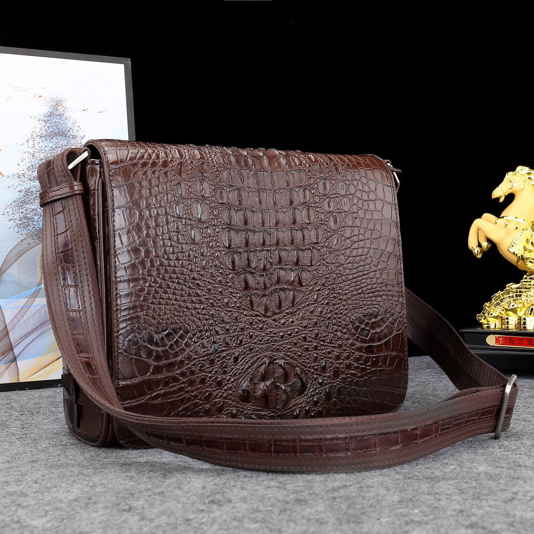 Genuine crocodile leather postal messenger handbag by Rossie Viren with adjustable strap and classic design.