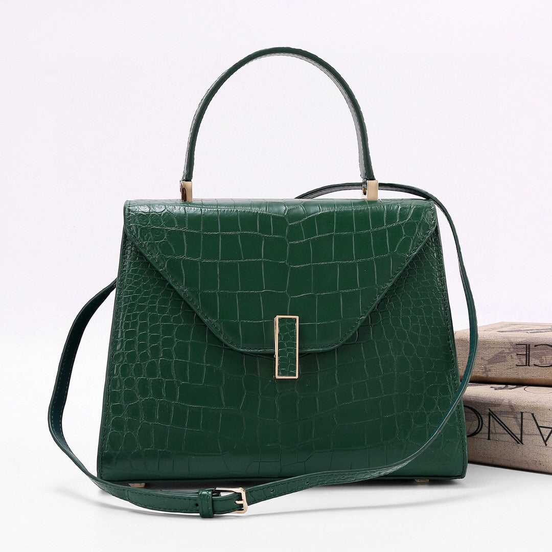 Dark green genuine crocodile skin leather top handle bag by Rossie Viren, featuring a sleek, luxurious design and sturdy handle.