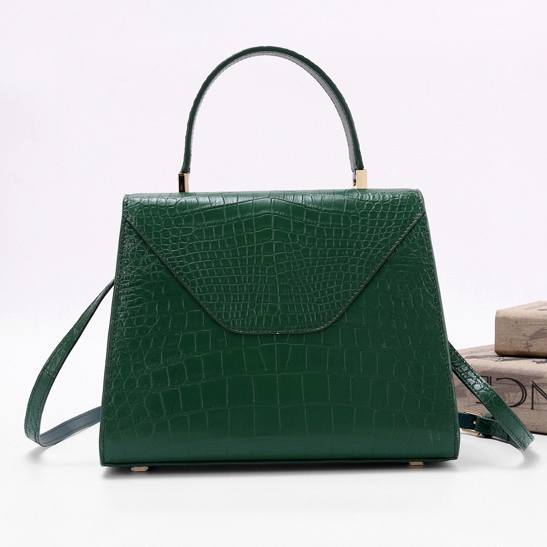 Dark green genuine crocodile skin leather top handle bag by Rossie Viren with a sleek, structured design and sturdy top handle.