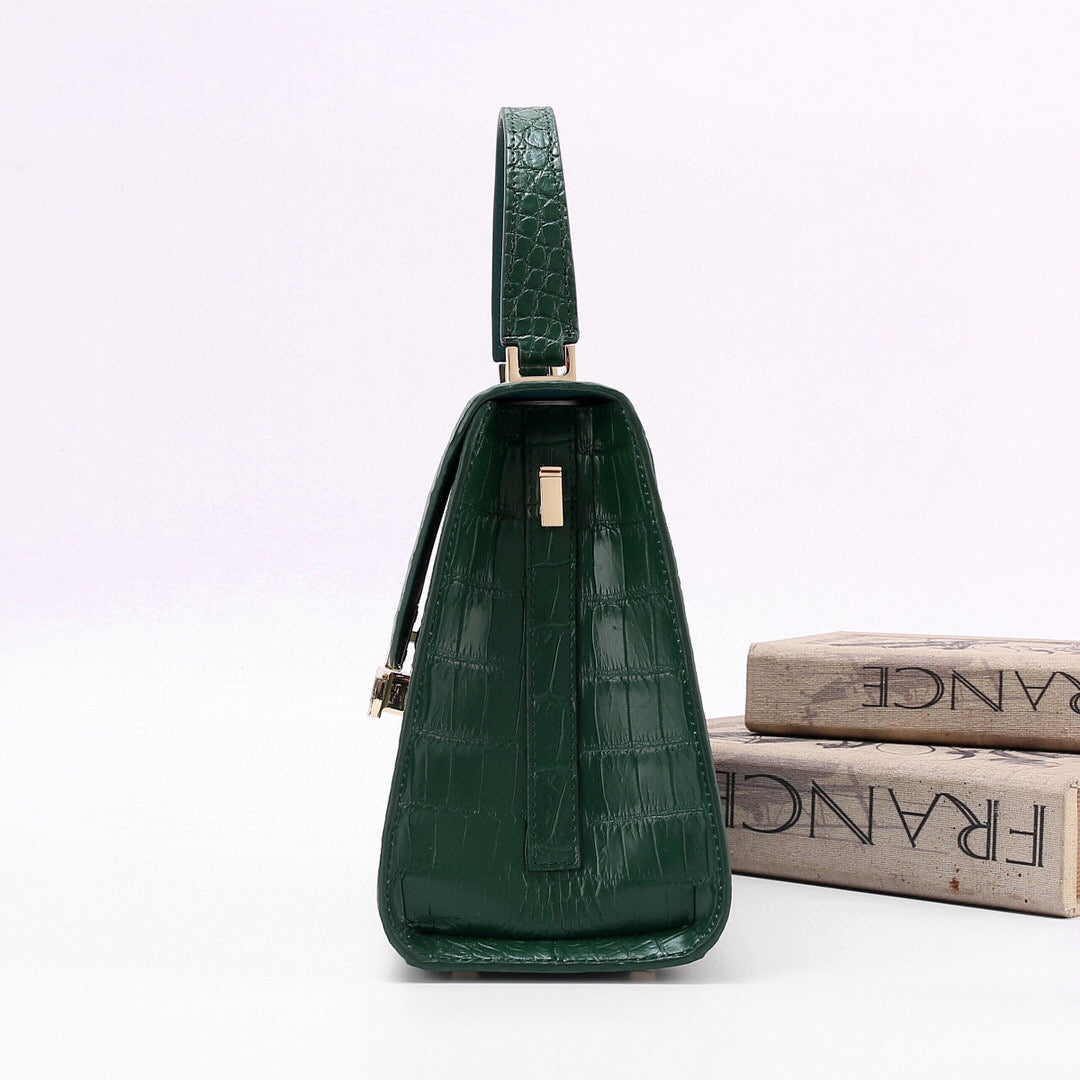 Dark green genuine crocodile skin leather top handle bag by Rossie Viren with a structured design and top handle for elegant carrying.