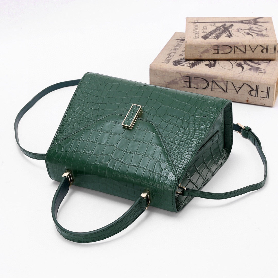 Dark green genuine crocodile skin leather top handle bag by Rossie Viren, featuring a sleek, structured design with sturdy handles.