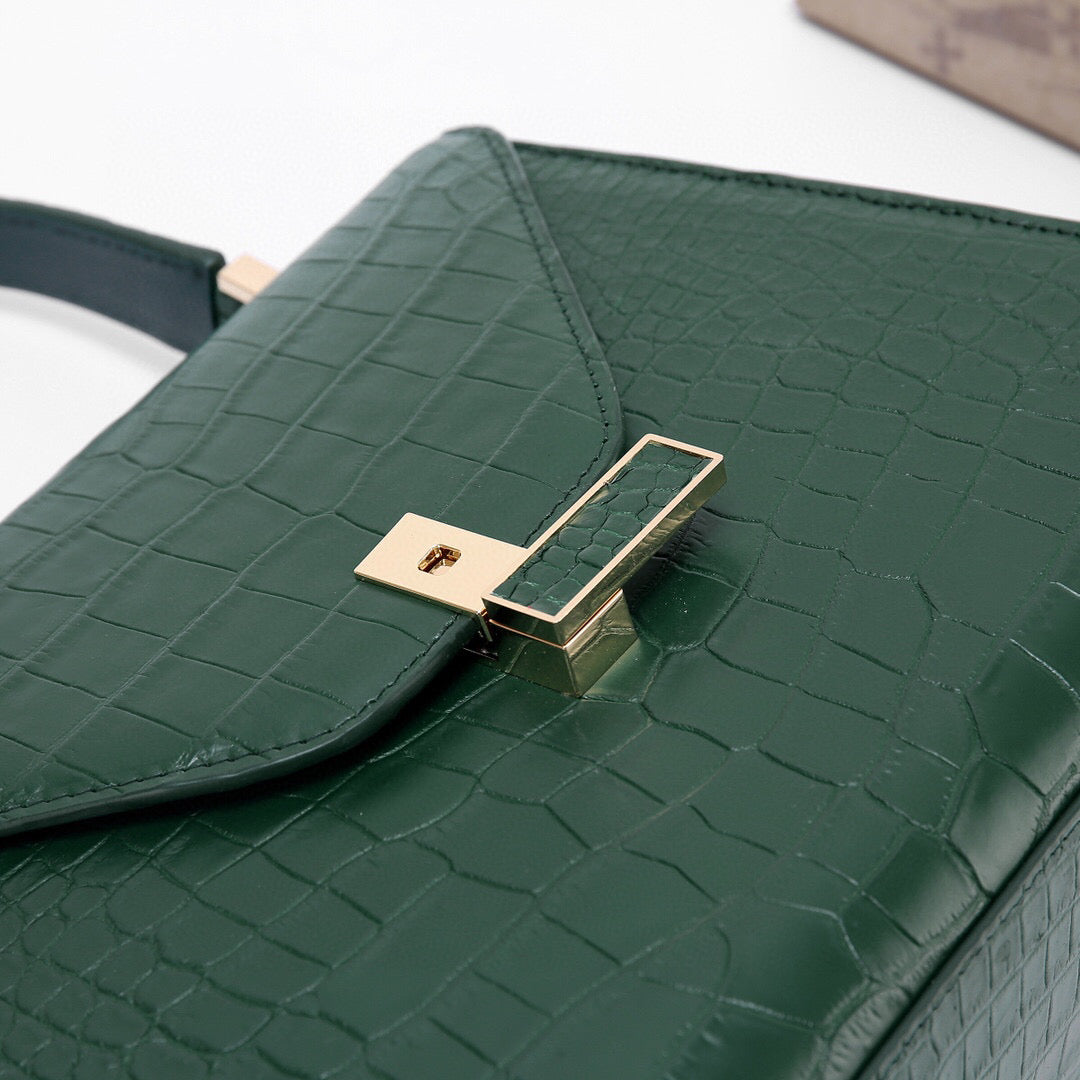 Dark green genuine crocodile skin leather top handle bag by Rossie Viren, featuring a sleek, luxurious design with a sturdy handle.