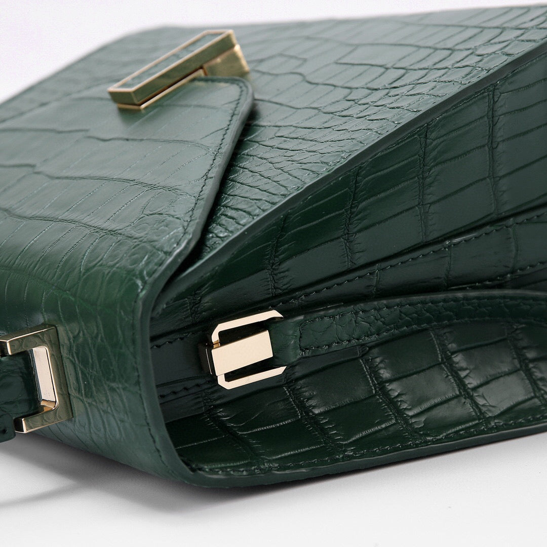 Dark green genuine crocodile skin leather top handle bag by Rossie Viren, featuring a sleek, luxurious design with sturdy handles.