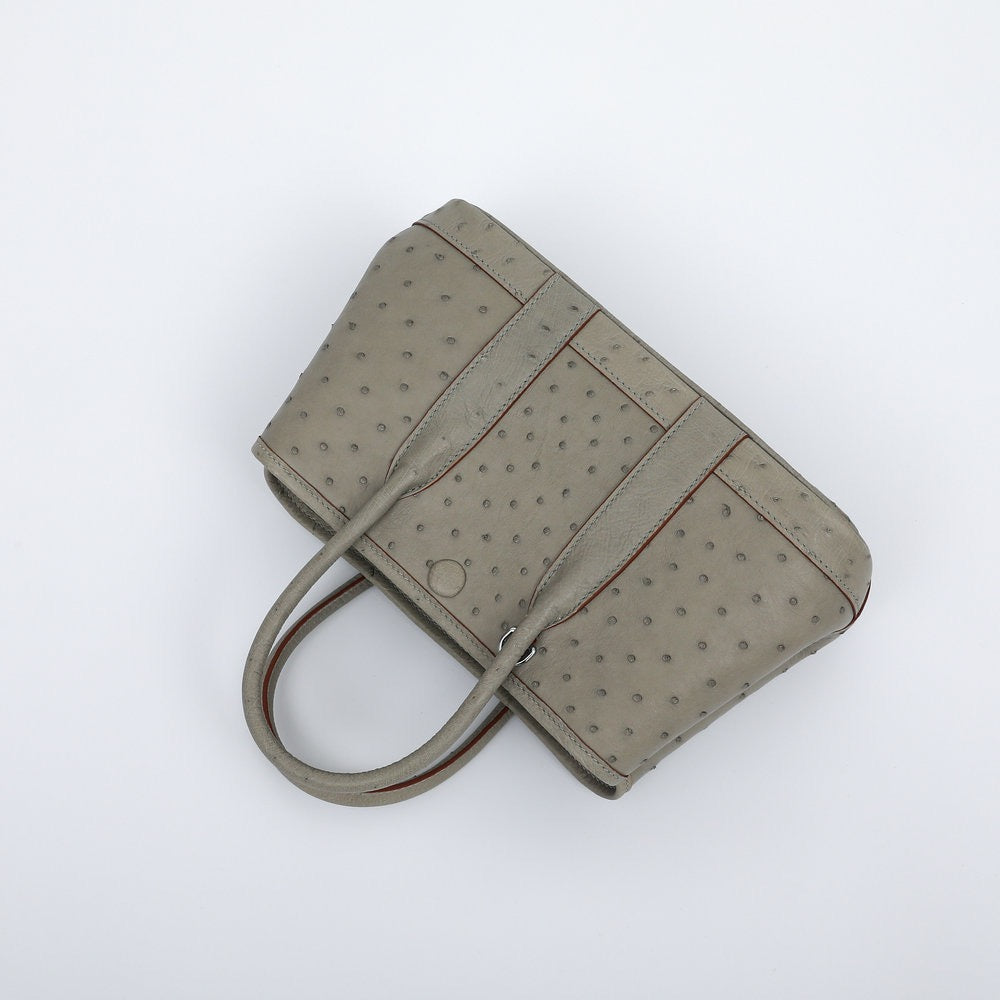 Genuine ostrich skin leather small tote bag by Rossie Viren, featuring textured black surface and sturdy handles.